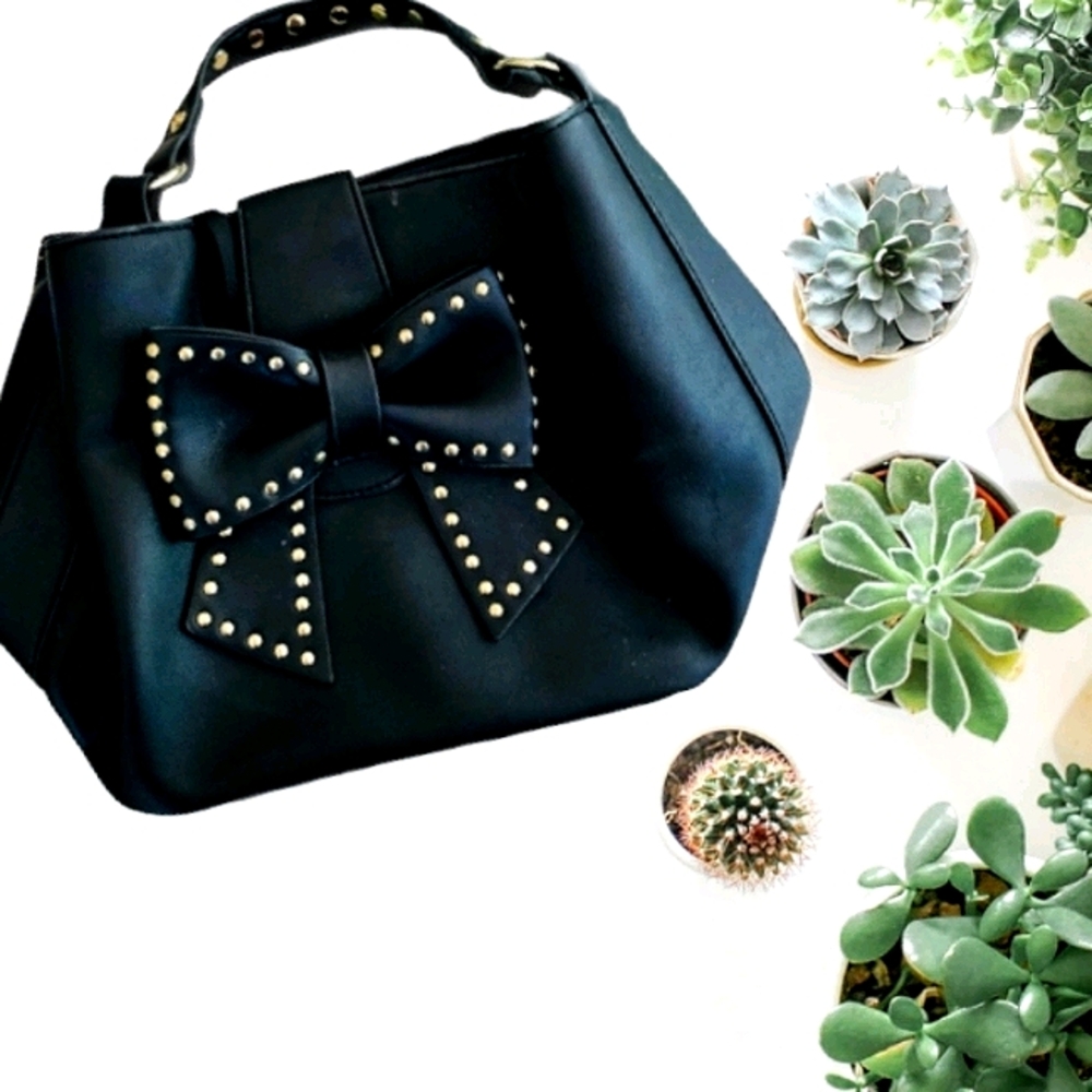 Betsey Johnson bucket bag displaying large bow
